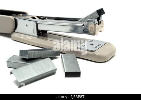 Stapler with staples on a white background. Gray Stapler Isolate Stock Photo
