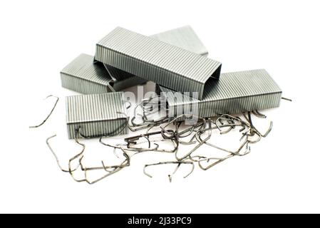 Staples from a stapler on a white background. Isolate of a bunch of staples scattered on the surface Stock Photo