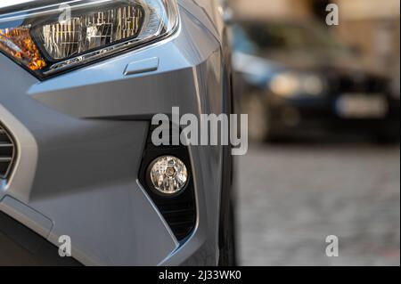 close up detail on headlight of modern  car,  part of the front bumper Stock Photo