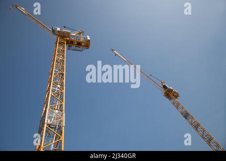 Two cranes working in tandem on a construction site in the UK Stock Photo