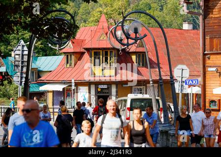 Zakopane, Poland - September 12, 2016: Unidentified people in the crowd are walking down Krupowki Street. In the background, you can see the roof of a Stock Photo