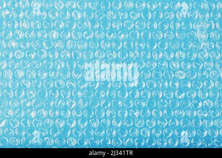 Packing bubble wrap for parcels on a blue background in full screen Stock Photo