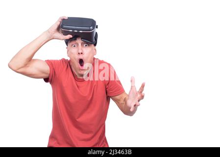 Shocked man in VR headset looking at camera Stock Photo