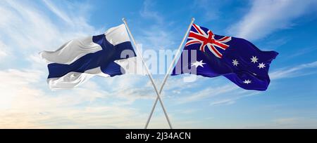 two crossed flags Australia and finland waving in wind at cloudy sky ...