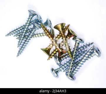 A top shot of screws with cross countersunk heads on a white background Stock Photo