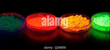 top view of colorful traditional holi powder in bowls isolated on dark background . happy holi.Concept Indian color festival called Holi Stock Photo