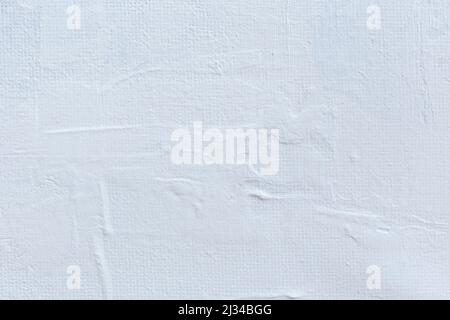Macro close-up of white acrylic paint on canvas. High resolution full frame textured blank canvas background. Copy space. Stock Photo