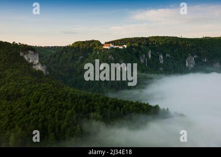 View from Eichfelsen to Wildenstein Castle with morning fog, sunrise, near Irndorf, Obere Donau Nature Park, Upper Danube Valley, Danube, Swabian Alb, Baden-Württemberg, Germany Stock Photo