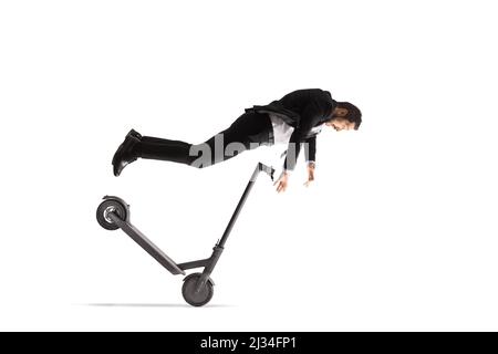 Businessman falling from an electric scooter isolated on white background Stock Photo
