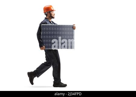 Male worker walking and carrying a solar panel isolated on white background Stock Photo