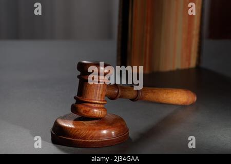 Law book with a wooden judges gavel on table in a courtron Stock Photo