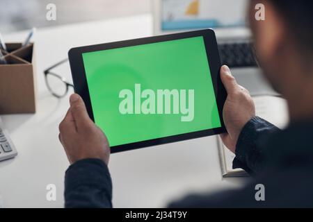 Checking out the website from a users perspective. Cropped shot of an unrecognizable businessman sitting alone in his office and using a digital Stock Photo
