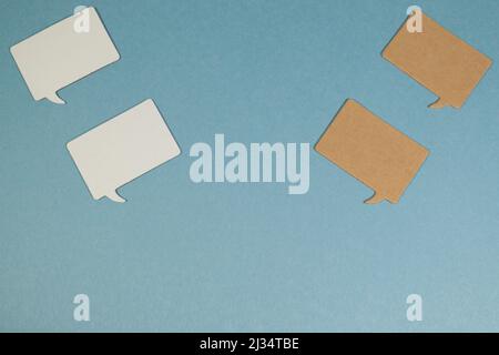Small Rectangular speech bubbles against light blue background Stock Photo