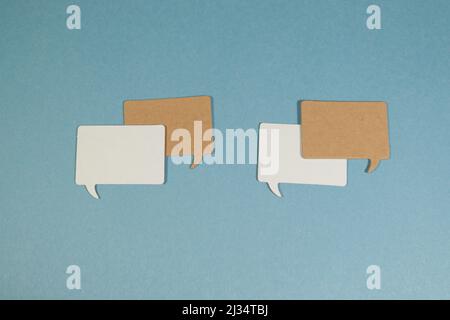 Small Rectangular speech bubbles against light blue background Stock Photo