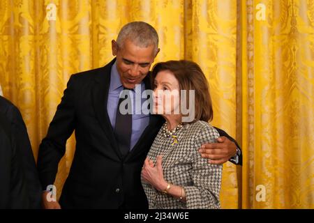 Washington, DC. 5th Apr, 2022. Former United States President Barack Obama hugs Speaker of the US House of Representatives Nancy Pelosi (Democrat of California) as US President Joe Biden signs an executive order mandating a rule change in the Affordable Care Act to make healthcare more affordable for families, following his remarks in the East Room of the White House in Washington, DC, on April 5, 2022. Credit: Chris Kleponis/Pool via CNP/dpa/Alamy Live News Stock Photo
