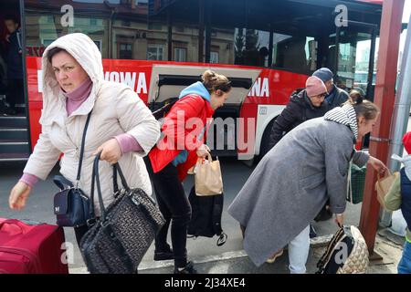 Przemysl, Poland. 4th Apr, 2022. Refugees collecting their belongings to get on the bus for the train station and then to their new homes in Poland and abroad. Tesco in Przemysl is a former grocery-store turned Humanitarian aid Center where many Ukrainian refugees go as soon as they cross over the border into Poland. Dozens of aid organizations are set up and providing shelter, logistical support, SIM cards, internet food and health: everything to quickly care for and relocate refugees, all at no expense to them. Hundreds of volunteers show up from all over the world eager to assist and offe Stock Photo