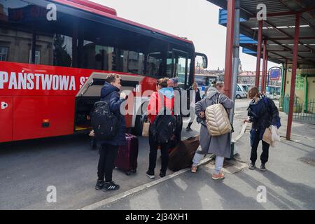 Przemysl, Poland. 4th Apr, 2022. Refugees collecting their belongings to get on the bus for the train station and then to their new homes in Poland and abroad. Tesco in Przemysl is a former grocery-store turned Humanitarian aid Center where many Ukrainian refugees go as soon as they cross over the border into Poland. Dozens of aid organizations are set up and providing shelter, logistical support, SIM cards, internet food and health: everything to quickly care for and relocate refugees, all at no expense to them. Hundreds of volunteers show up from all over the world eager to assist and offe Stock Photo