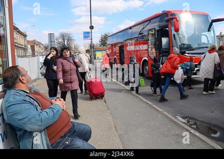 Przemysl, Poland. 4th Apr, 2022. Refugees collecting their belongings to get on the bus for the train station and then to their new homes in Poland and abroad. Tesco in Przemysl is a former grocery-store turned Humanitarian aid Center where many Ukrainian refugees go as soon as they cross over the border into Poland. Dozens of aid organizations are set up and providing shelter, logistical support, SIM cards, internet food and health: everything to quickly care for and relocate refugees, all at no expense to them. Hundreds of volunteers show up from all over the world eager to assist and offe Stock Photo