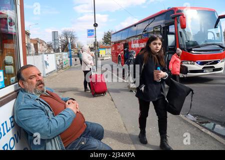 Przemysl, Poland. 4th Apr, 2022. Refugees waiting to get on the bus for the train station and then to their new homes in Poland and abroad. Tesco in Przemysl is a former grocery-store turned Humanitarian aid Center where many Ukrainian refugees go as soon as they cross over the border into Poland. Dozens of aid organizations are set up and providing shelter, logistical support, SIM cards, internet food and health: everything to quickly care for and relocate refugees, all at no expense to them. Hundreds of volunteers show up from all over the world eager to assist and offer their skills, with Stock Photo