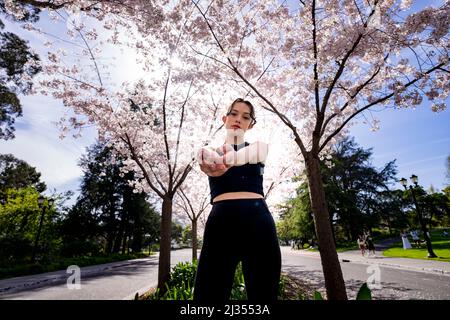 Teenage Female Dancer Under Cherry Trees at UC Berkeley Stock Photo