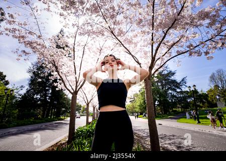 Teenage Female Dancer Under Cherry Trees at UC Berkeley Stock Photo