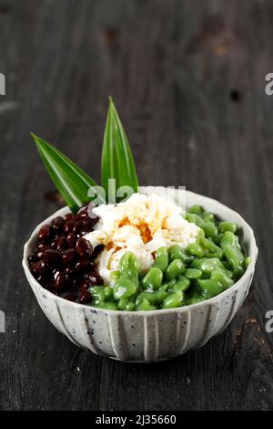 Malaysian Desserts Called Cendol. Cendol is Made From Crushed Ice Cubes, Red Bean. Also Popular in SIngapore. On Wooden Table Stock Photo
