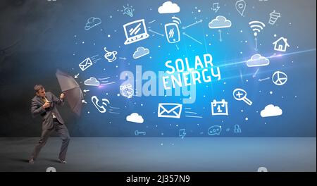 Businessman defending with umbrella, modern technology concept Stock Photo