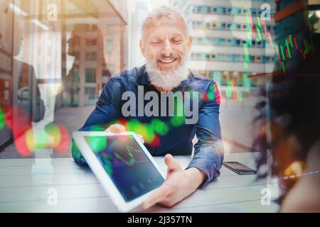 Businessman shows trading stock market chart on a tablet Stock Photo