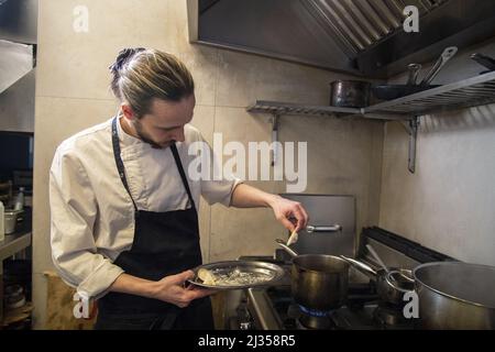 A professional chef making homemade fresh Italian tortellini pasta Stock Photo
