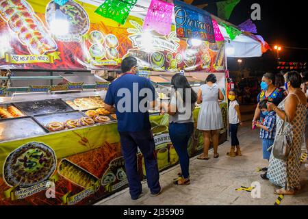 With the covid-19 restrictions easing, people in Merida Mexico start going out again while wearing their face masks, January 2022 Stock Photo