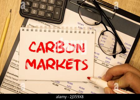 CARBON MARKETS. text on white paper near dollar bills. Stock Photo