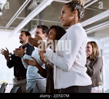 It was a passion inspiring presentation. Shot of a group of businesspeople clapping during a conference. Stock Photo