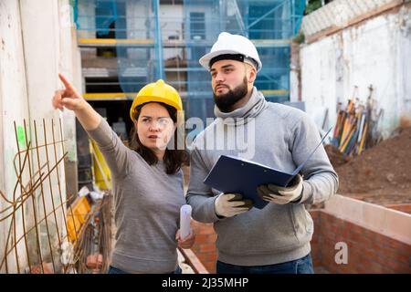 Architect and contractor discussing construction plan Stock Photo