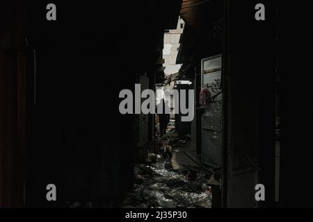 Kyiv, Ukraine. 05th Apr, 2022. Residents walk through a destroyed marketplace in Borodyanka, a small village in Kyiv Oblast. As the Russian forces withdrawal from the Kyiv area, the scope of damage and loss of human life as a result of the Russian Invasion has become evident. Instances of specifically targeting civilians whether with executions or targeted airstrikes on residential areas have come to light. Credit: SOPA Images Limited/Alamy Live News Stock Photo