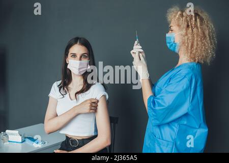Nurse hold a syringe preparing a shot of corona virus covid-19 for a patient arm. Pandemic prevention. Health care concept. Influenza pandemic medical Stock Photo