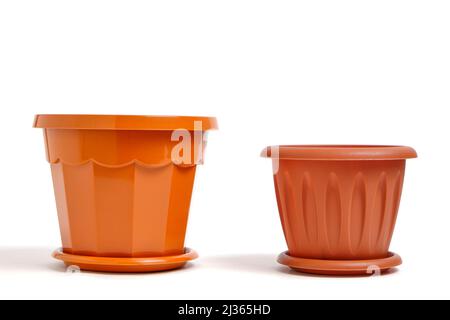 Two brown plastic empty flower pots white background Stock Photo