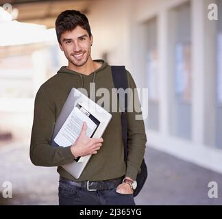 Education is the movement from darkness to light. Cropped portrait of a handsome young man standing outside while on campus. Stock Photo