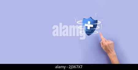 Businessman hold Shield with plus Low polygonal icon, medicine icon.Health shield.Medical logo template,protection symbol with cross sign,healthcare s Stock Photo