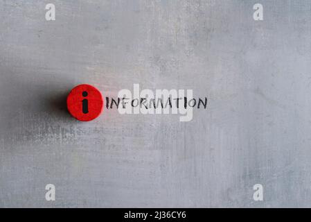 Red cubes with information icon on concrete background. Copy space for text. Stock Photo
