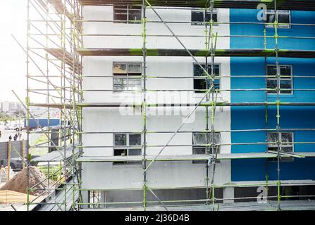 The demand for urban accommodation is on the rise. Shot of scaffolding and a building at a construction site. Stock Photo