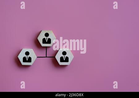 Wooden cube with worker icon and connected lines. Leadership, share, network, peer to peer concept Stock Photo