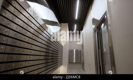 Modern entrance with mailboxes. Modern, new hall in a multi-storey building. Corridor with postboxes on walls in new residential building. Stock Photo