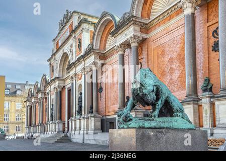 Facade of the museum, Ny Carlsberg Glyptotek, of fine arts, in the foreground the bronze statue of a lion attacking a snake. Copenhagen, Denmark