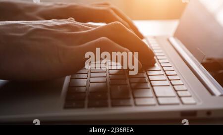 Man freelancer opens laptop to continue working on project Stock Photo