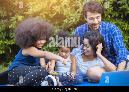 Family happy playing enjoy picnic together in the park garden home backyard. Stock Photo
