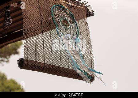 dream catcher hanging from a roof floating in the wind Stock Photo