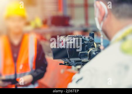 Camera man recording Video footage with professional Mirrorless camera with Gimbal stabilizer. Stock Photo