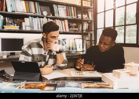 creative designer mix race working together discussion in modern office. Stock Photo