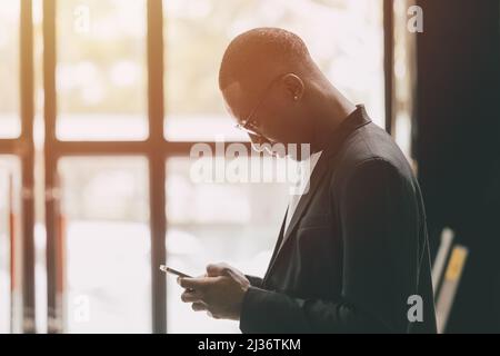 black business man using smartphone touch screen for contact people Stock Photo