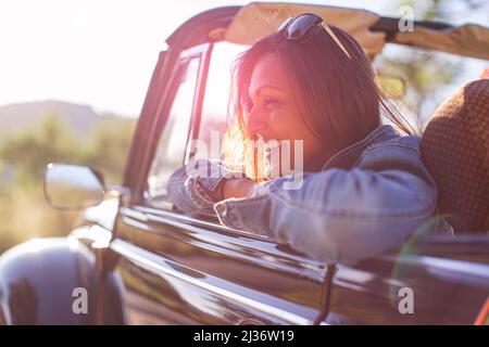 Asian woman in her classic VW Beetle Stock Photo